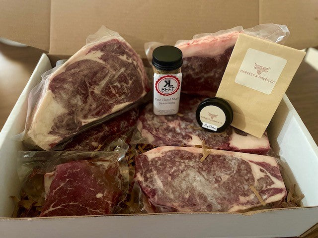 Box of premium dry-aged angus beef cuts from KL Beef Co., including steaks and seasoning, packed for online delivery from Nebraska.